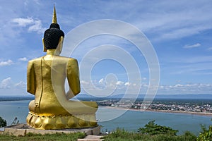 The big golden Buddha statue of Phu Salao temple with Mekong River flows through the Pakse city,Laos photo