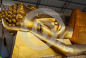 Big golden head of Reclining Buddha Image (Phra Norn)