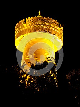 Big golden prayer wheel at night