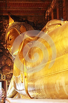 Big golden reclining Buddha image at Wat Pho temple, Thailand