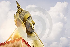 Big golden Reclining Buddha Statue with sky