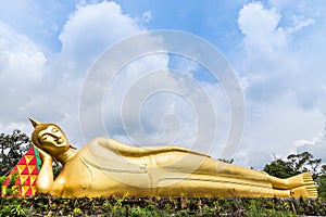 Big golden reclining buddha statue in thai temple