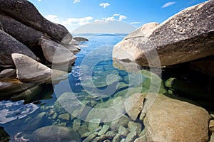 Big granite boulders at pristine lake shore photo