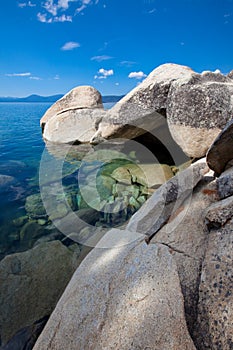 Big granite boulders at pristine lake shore