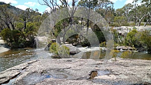 Big granite boulders with a swiftly running creek among them captured in spring.