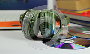 Big green earphones with disks and the computer