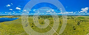 A big green field at Rangers Vally Cattle with beautiful blue sky in Australia with a wetland