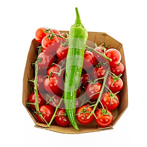 Big green spicy on the background of tomatoes on a branch small culinary design vegetables