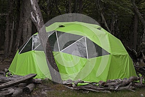 Big green tent in the forest camp.