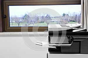 Big grey copier in grey office