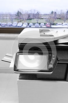 Big grey copier in grey office