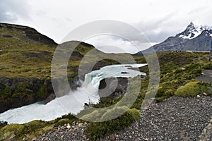 Big grey mountains with a waterfall in front in Torres del Paine National Park in Chile, Patagonia