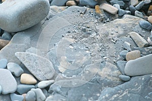 Big grey rock stone with small pebble.