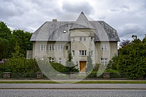 Big grey stone house looking like a mini castle