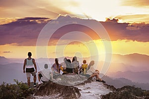 Big group friends mountain top sunset