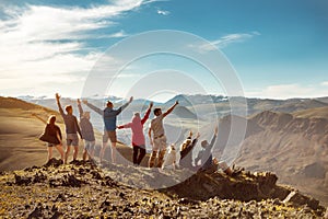 Big group happy friends or tourists in mountains