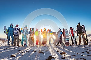 Big group of skiers and snowboarders at sunset mountain