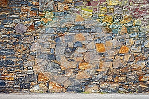 Big grunge colorful stone blocks wall.