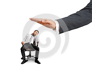 Big hand ready to slap lazy businessman