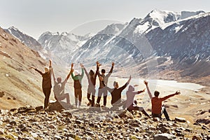 Big active company of happy friends in mountains