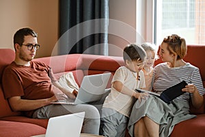 Big happy family with children watching movies playing games on laptop