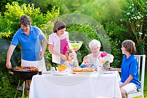 Big happy family enjoying bbq grill in the garden