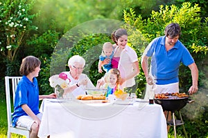 Big happy family enjoying bbq grill in the garden