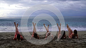 Big happy family or group of five friends is having fun against sunset beach. Beach holidays concept.