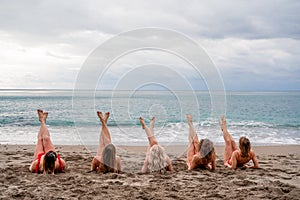 Big happy family or group of five friends is having fun against sunset beach. Beach holidays concept.