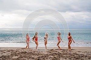 Big happy family or group of five friends is having fun against sunset beach. Beach holidays concept.