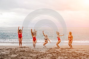 Big happy family or group of five friends is having fun against sunset beach. Beach holidays concept.