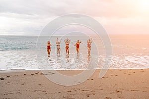 Big happy family or group of five friends is having fun against sunset beach. Beach holidays concept.