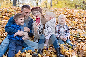 Big happy family having fun in autumn Park. Mum dad and three children