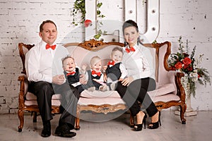 Big happy family: mother, father, triplet sons