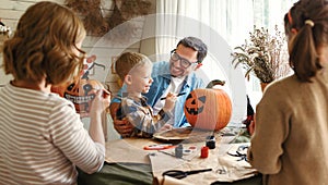 Big happy family parents with two kids preparing for Halloween celebration