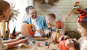 Big happy family parents with two kids preparing for Halloween celebration