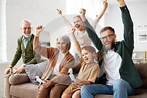 Big happy multi generation family playing video games at home