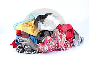 Big heap of colorful clothes isolated on white background