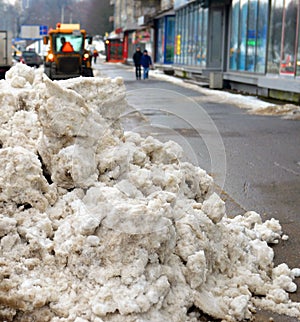 Big heap of snow during cleaning of the street