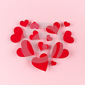 Big heart of soar red hearts on soft pink color background. Concept for Valentine day.