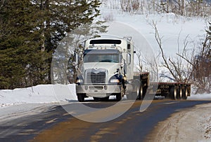 Big heavy transport truck on a forest road in Quebec