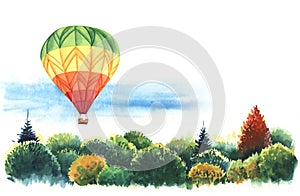 Big hot air balloon flying over tops of trees autumn forest.