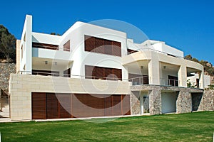 Modern Luxury Villa with Stone and Wood Accents Under Clear Blue Sky