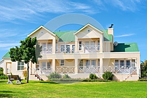 Big house - front view, grass, bench, tree