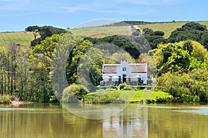 Big house next to lake and hills