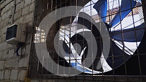 Big industrial fan in a wall of plant. Ventilation of factory building.