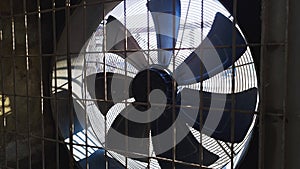 Big industrial fan in a wall of plant. Ventilation of factory building.
