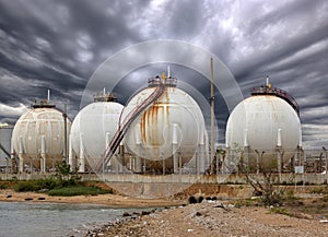 Big Industrial oil tanks in a refinery and Drainage system with