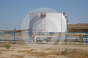 Big Industrial oil tanks in a refinery .Large white industrial tanks for petrochemical or oil or fuel or water in refinery or