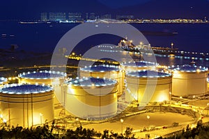 Big Industrial oil tanks in a refinery at night